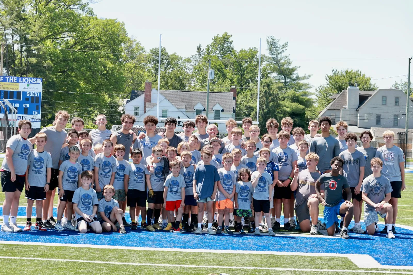 Campers and Bexley High School players gathered on the field at the end of the youth football camp